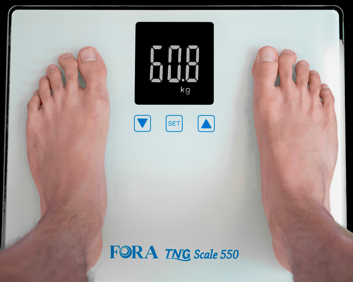 Person standing on FORA TN’G Scale 550 digital Bluetooth weight scale, LCD display showing 60.8 kg measurement.