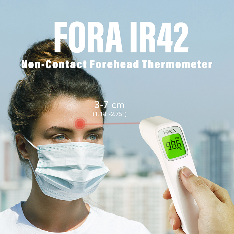 Person using FORA IR42 non-contact infrared forehead thermometer, measuring from 3–7 cm distance for safe and hygienic temperature check.